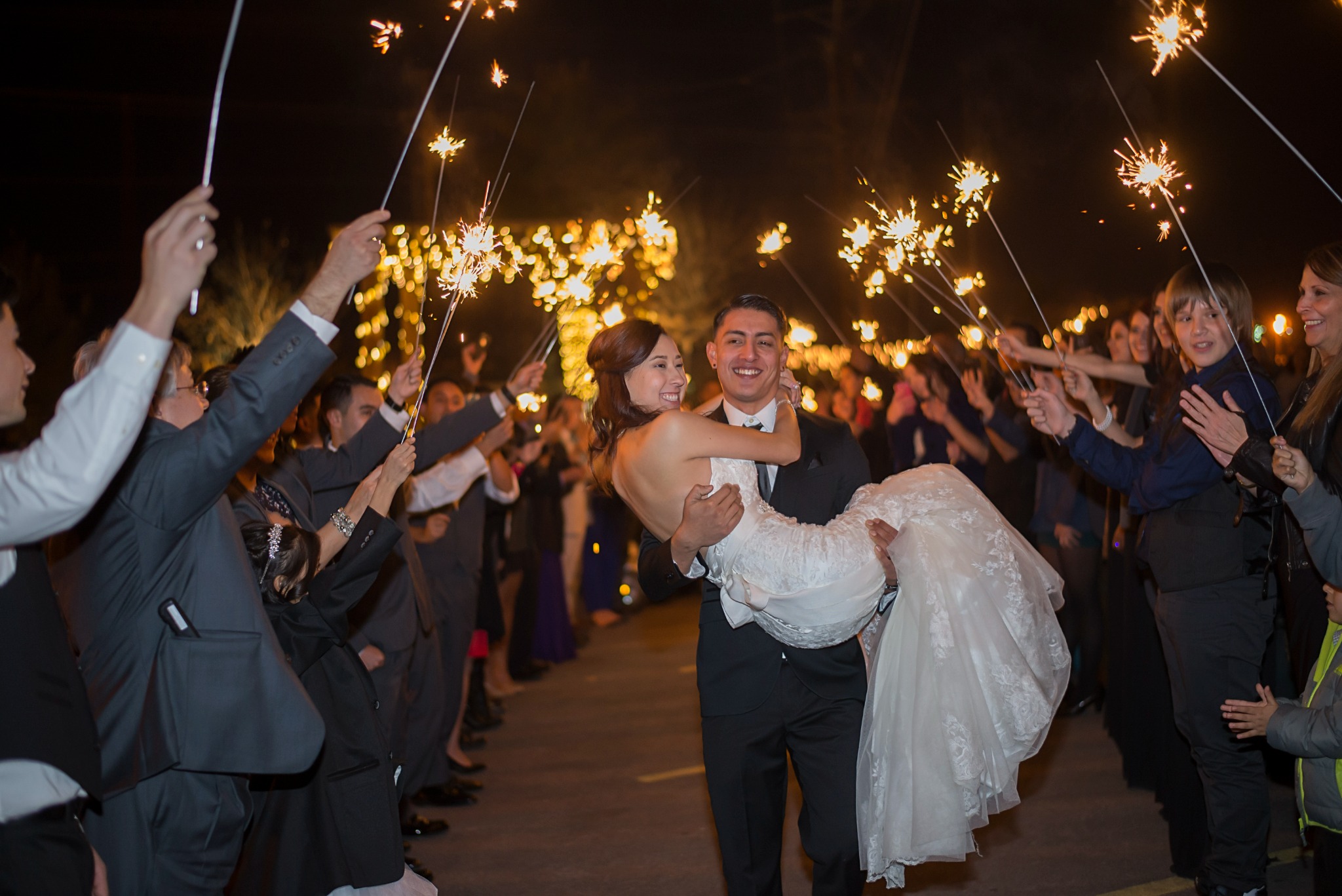 Newlyweds laughing during their sparkler exit